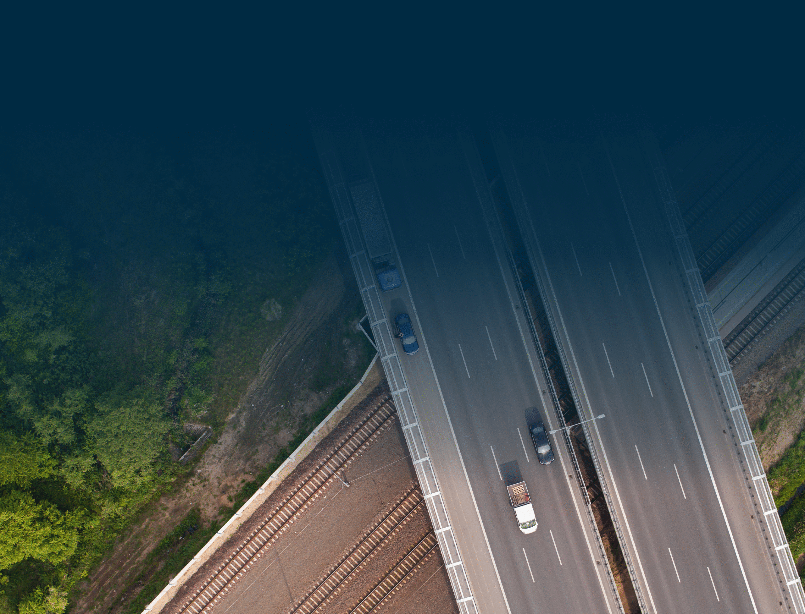 Aerial view of highway overpass and greenery.