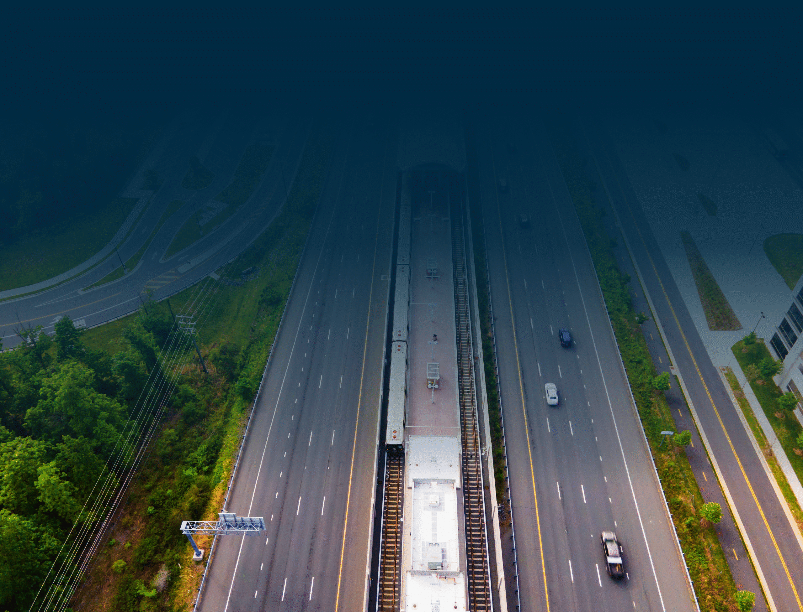 Aerial view of highway and train tracks.