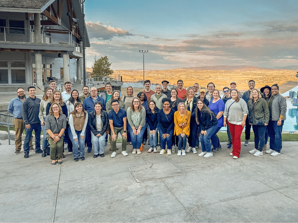 Group photo with mountain backdrop.